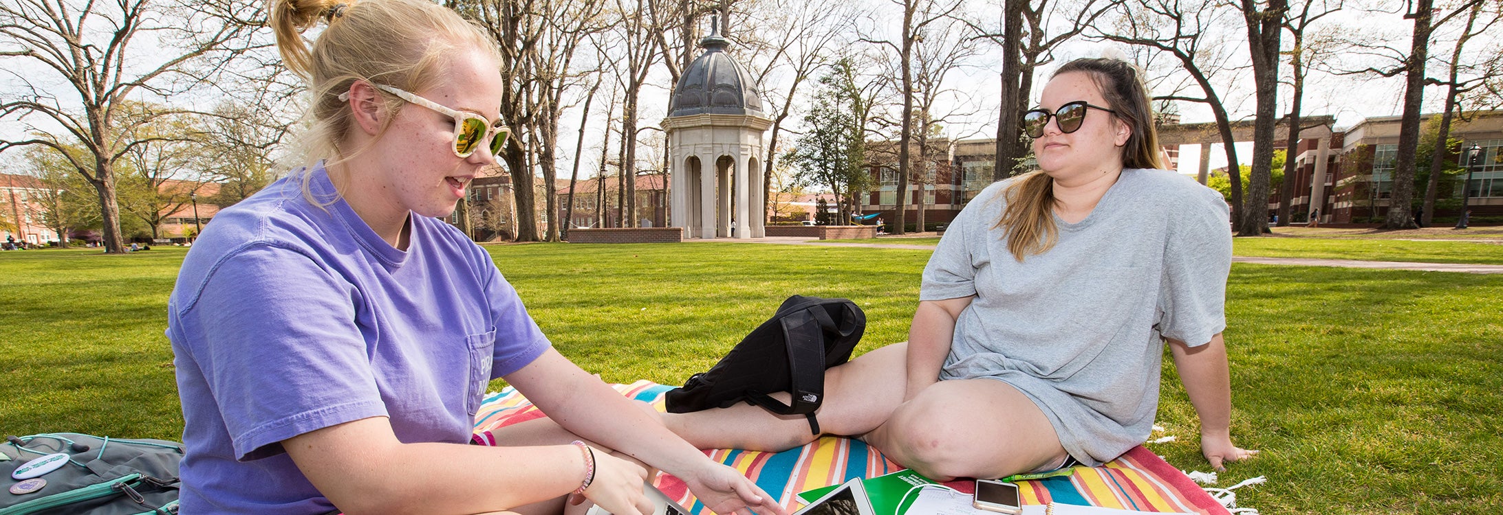 Two women sitting on the mall